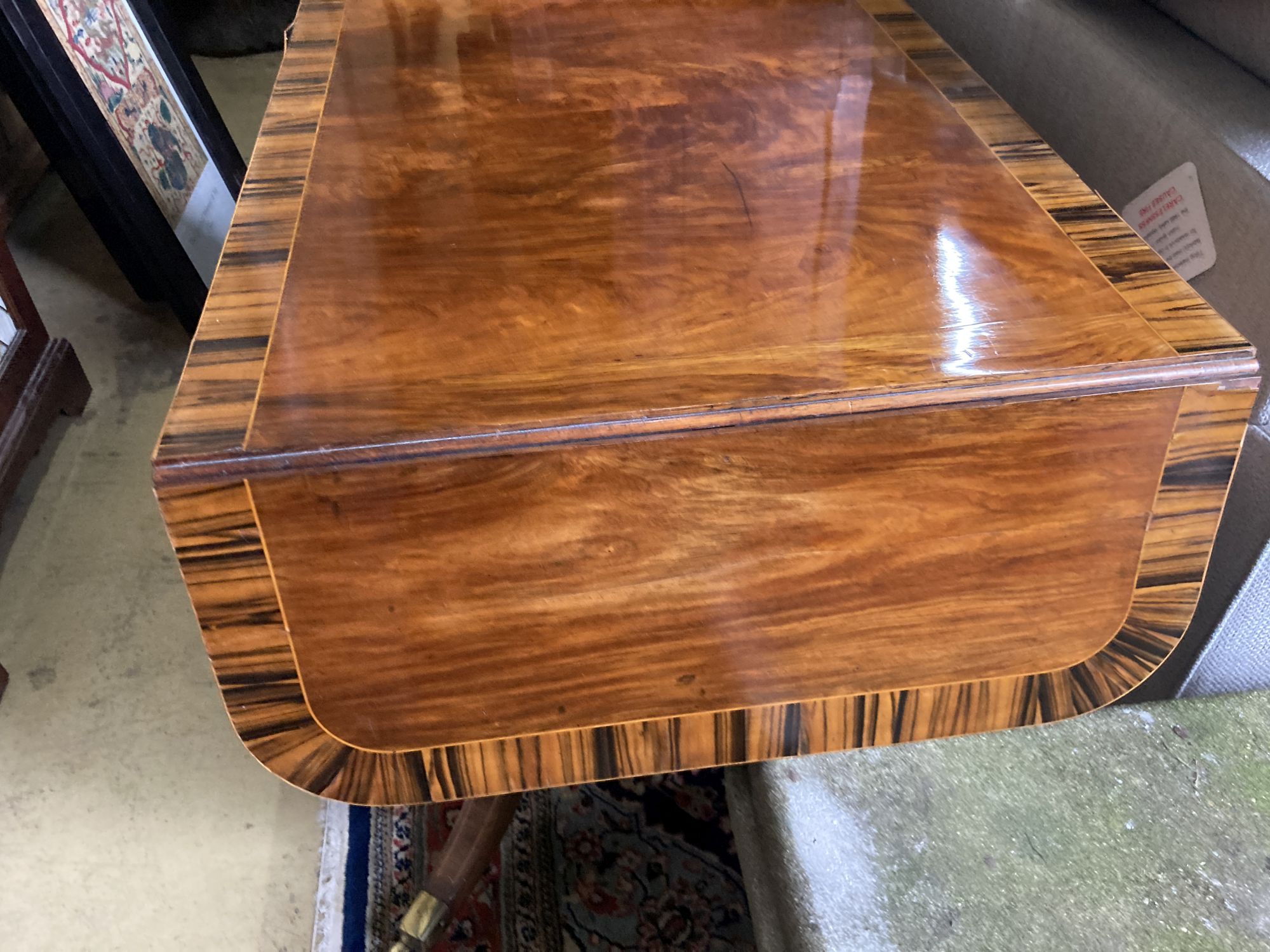 A Regency mahogany sofa table banded in coromandel, W. 3ft. D. 2ft. 2in. H. 2ft 4in.